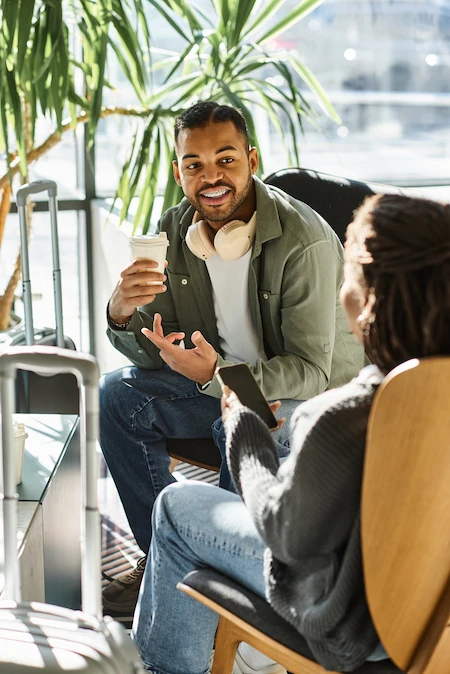 Image of man in green shirt smiling, receiving information on MindWise service by TestWise.