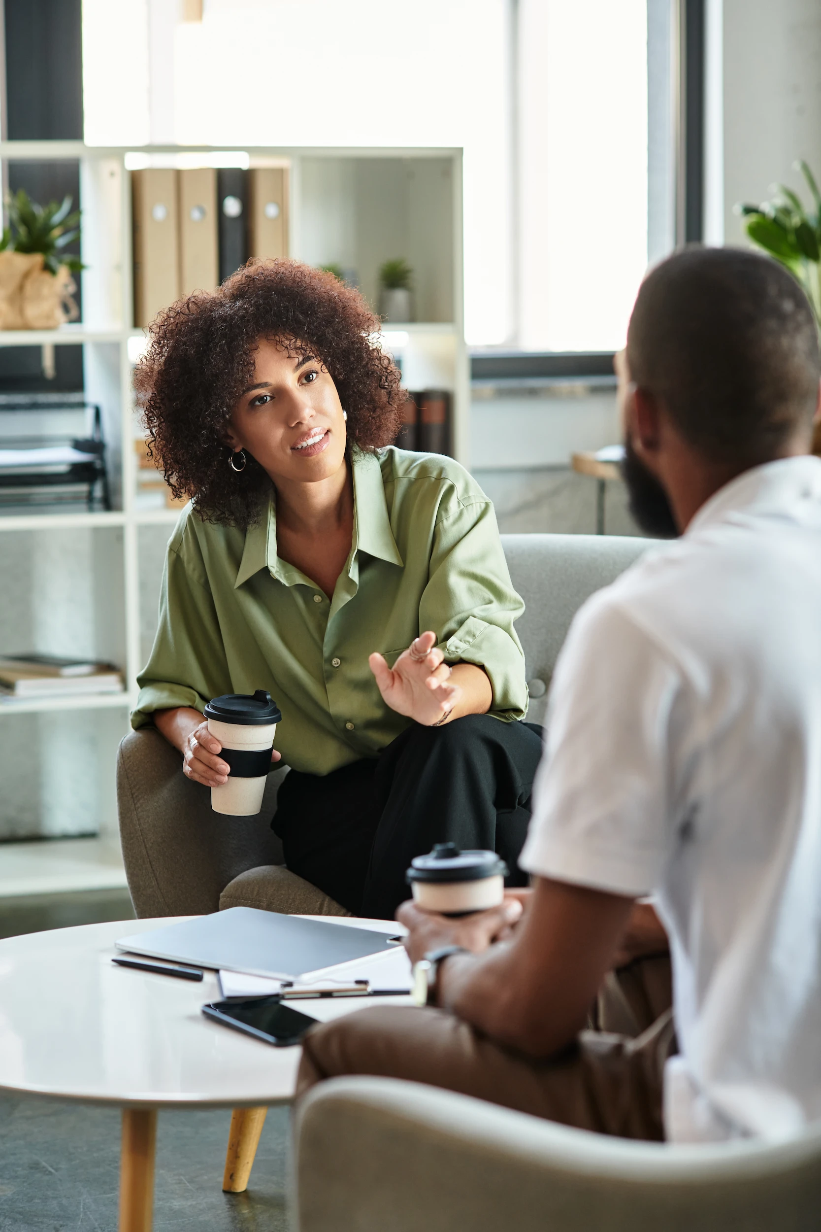 Image of woman in green shirt counselling an employee about drug test results.